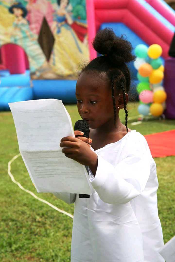 ROBA 6year old student reading a manifest at a...